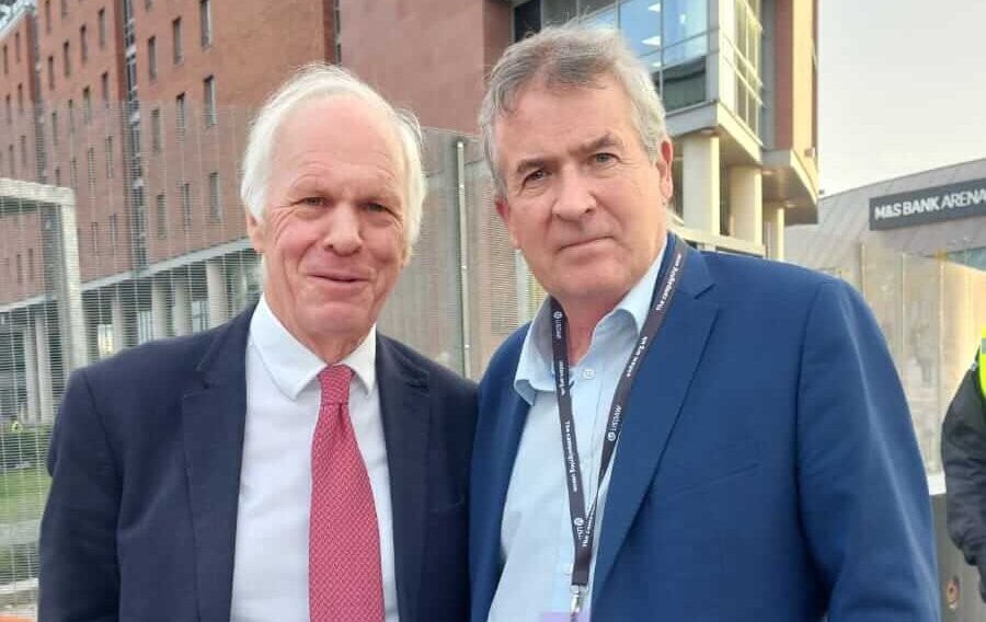Two men stood outside facing the camera.
